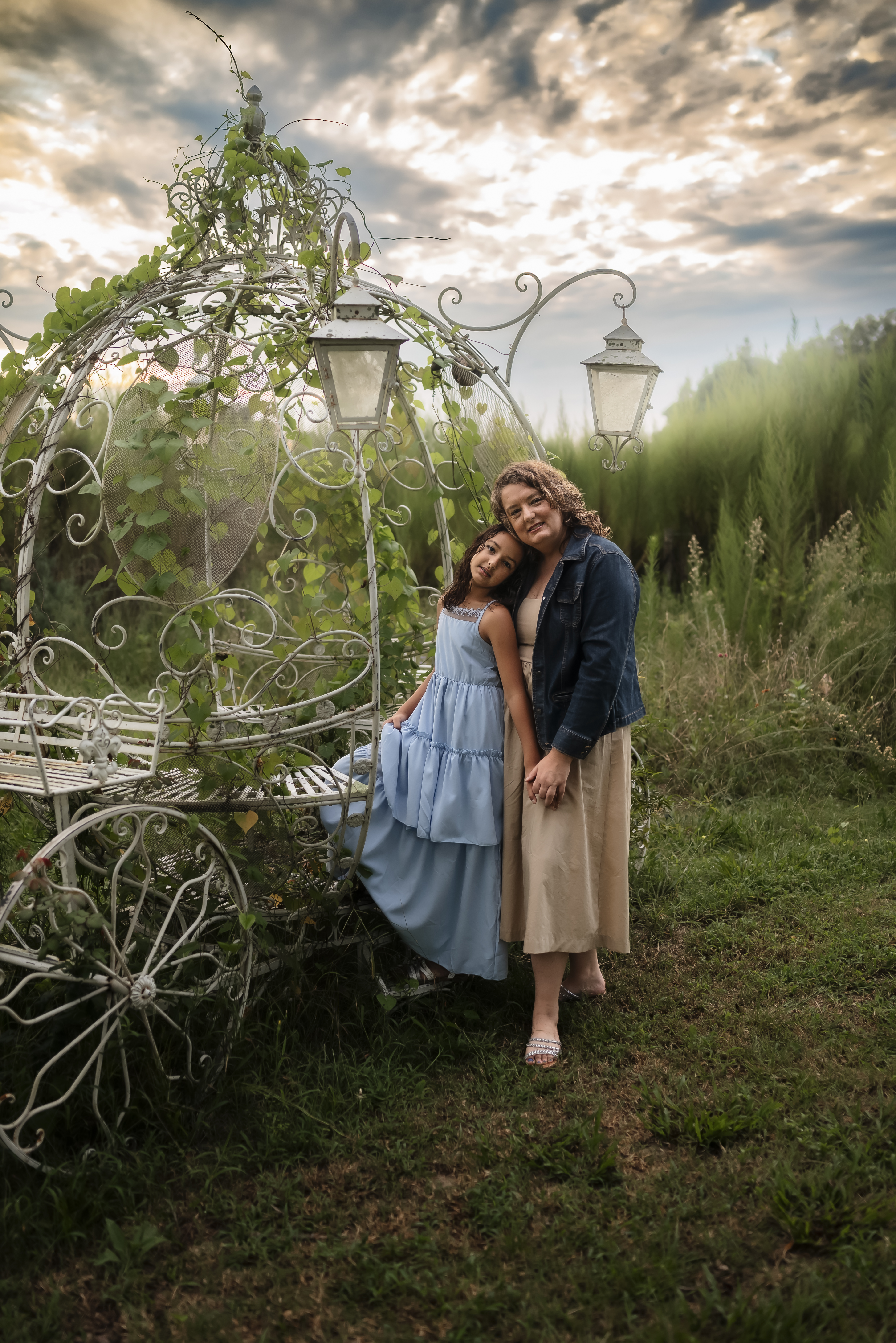 mother and daughter holding hands on a princess carriage at monarch ranch butterfly conservatory garden in south carolina