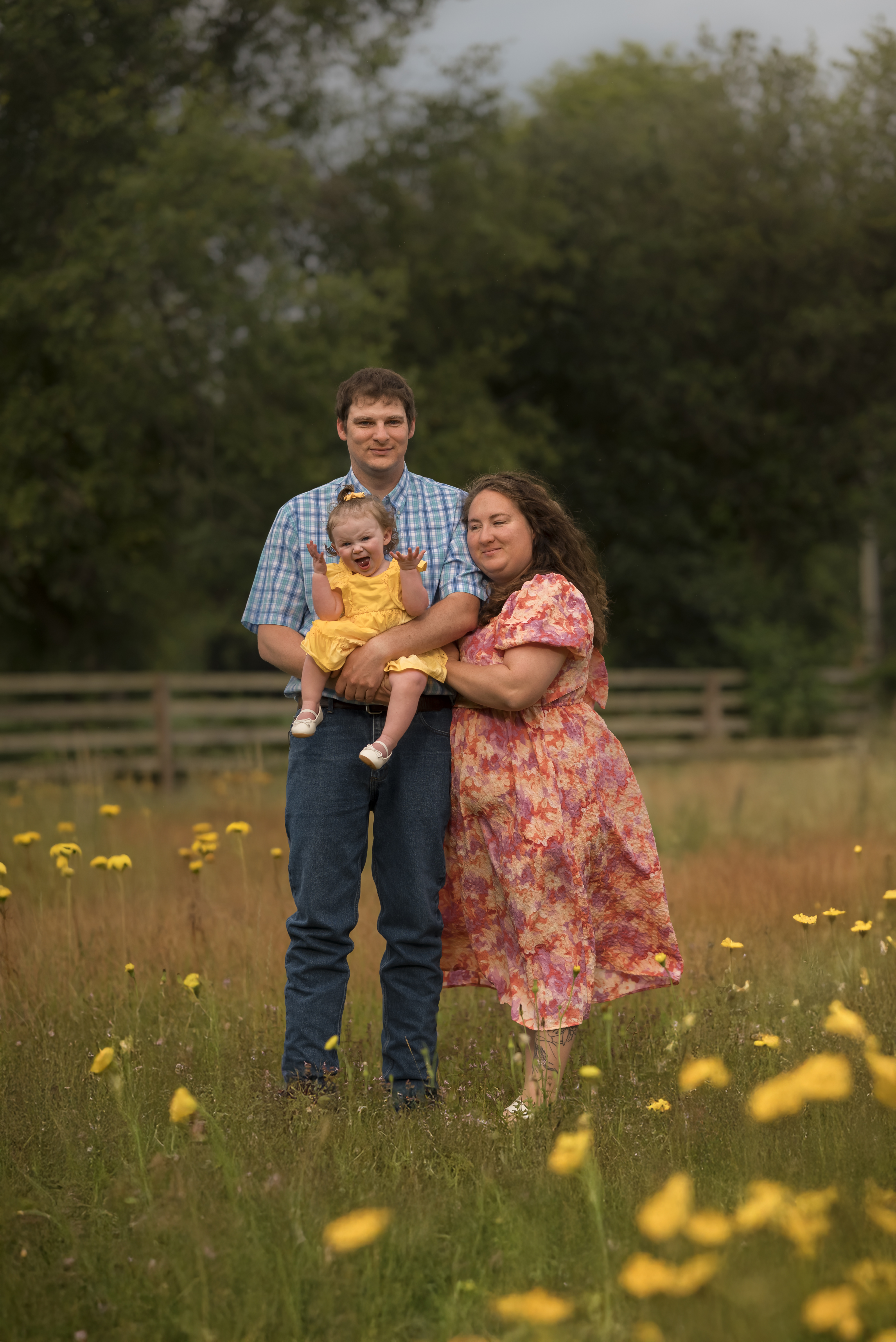family photo in field of yellow flowers